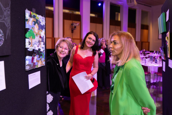 Dr Anne Aly MP observing SCaW artwork NYSF auction (credit NYSF)